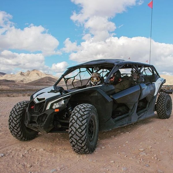 Can-Am Maverick X3s parked with 3 riders