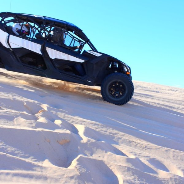 Can-Am Maverick X3s driving down a sand dune