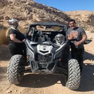 two people near a parked Can-Am