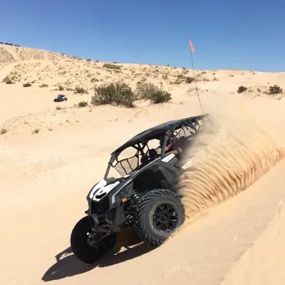 Can-Am Maverick throwing sand in the air