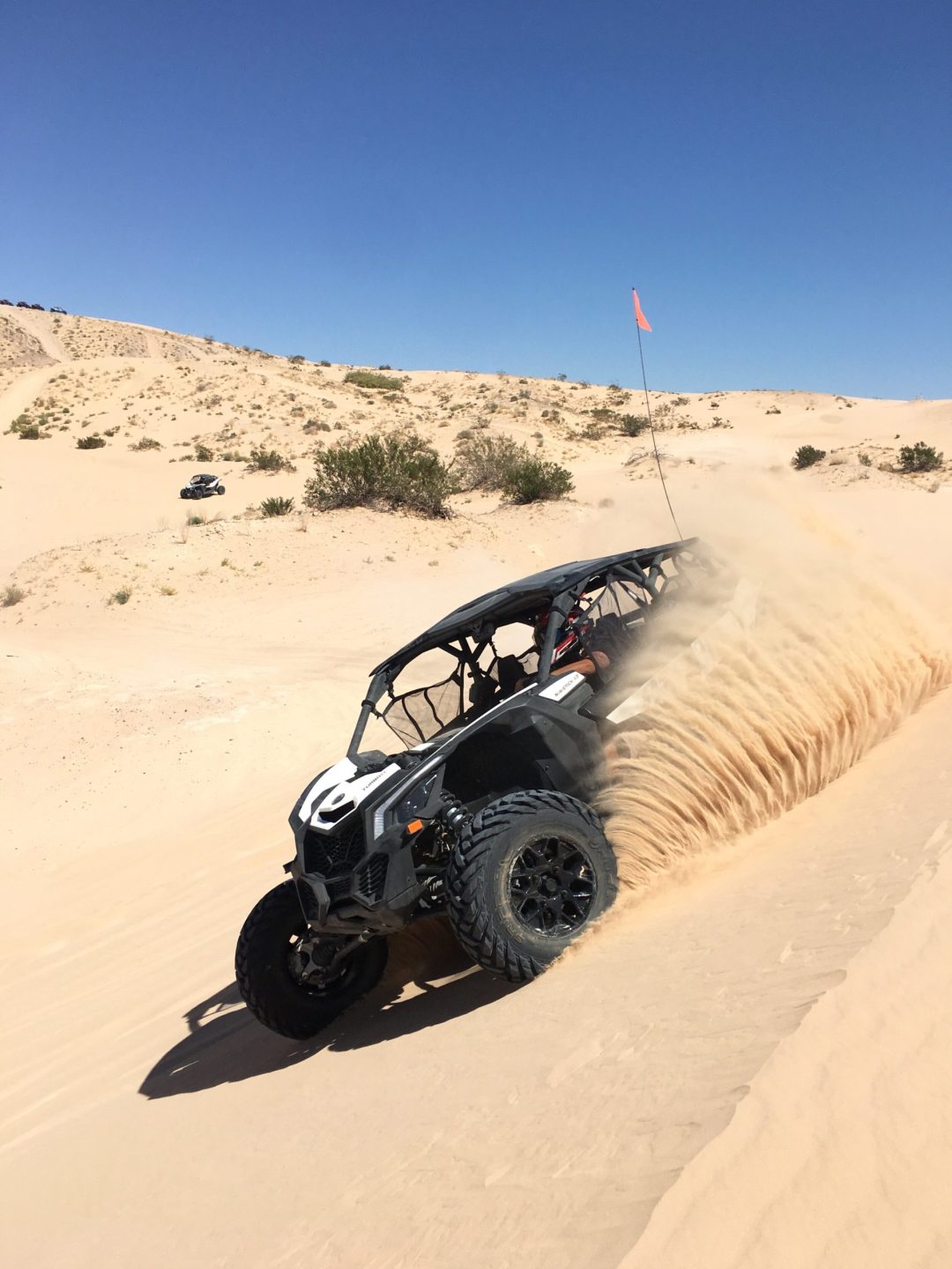 Can-Am Maverick throwing sand in the air